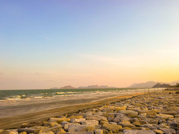 Scenic view of beach against sky during sunset