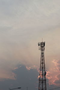 Low angle view of communications tower against sky during sunset