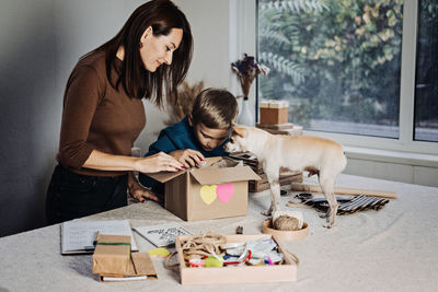 Charity care pet box, donation box, gift package for pet shelter. happy family, mother, kid and dog