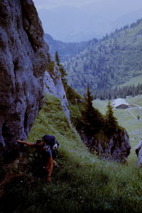 Rear view of man climbing on mountain