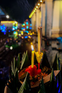 Close-up of lit candle at night