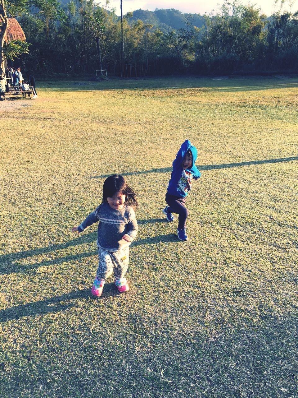 childhood, full length, two people, togetherness, day, grass, playing, real people, tree, leisure activity, field, outdoors, girls, boys, bonding, nature, people