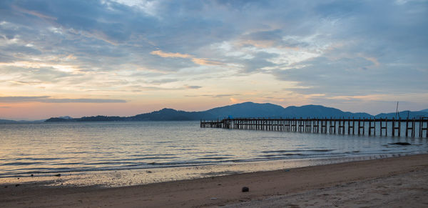 View of beach against cloudy sky