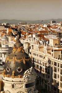 High angle view of statue against buildings in city