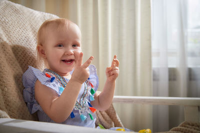 Portrait of cute girl playing with toy on table at home