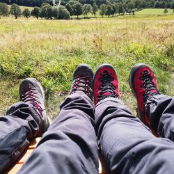 Low section of man relaxing on field