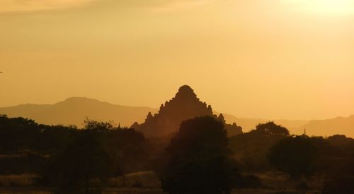 Silhouette of temple against sky during sunset