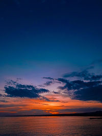 Scenic view of sea against romantic sky at sunset