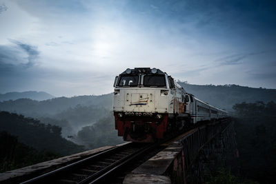 Train on railroad track against sky