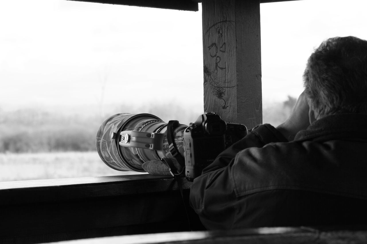 REAR VIEW OF MAN PHOTOGRAPHING