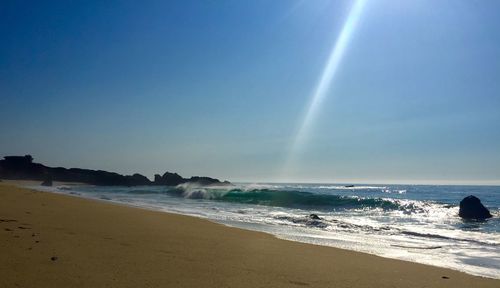 Scenic view of beach against clear sky