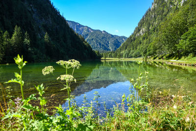 Scenic view of lake and mountains against sky