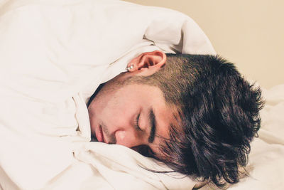 Close-up of baby sleeping in bed