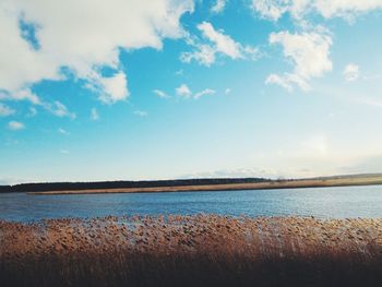 Scenic view of lake against cloudy sky