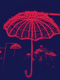 Low angle view of illuminated ferris wheel against sky at night