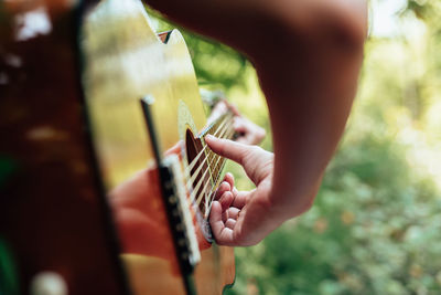 Cropped image of person playing guitar