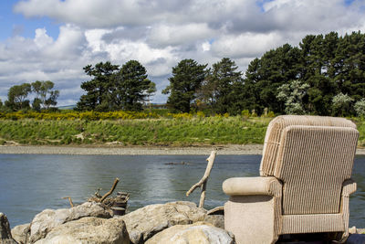 Old couch on the rocks by the river