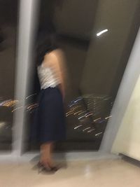 Blurred motion of woman at night