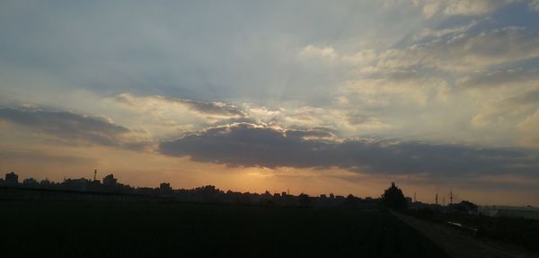 Panoramic view of silhouette city against sky during sunset