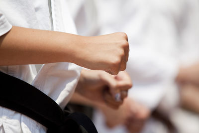 Midsection of child practicing karate