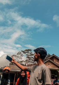 Man and woman standing on road against sky