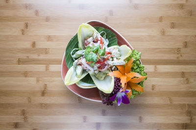 High angle view of chopped fruits in bowl on table