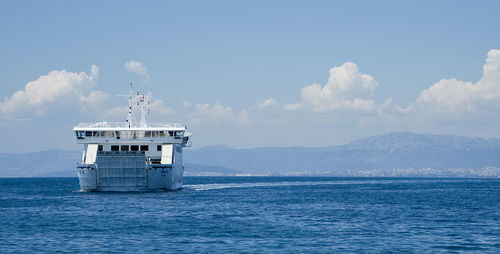 Scenic view of ferry and sea against sky