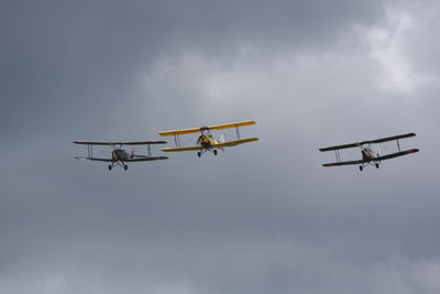 Low angle view of helicopter against sky