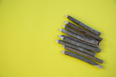 High angle view of stack on table against yellow background