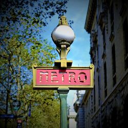 Low angle view of art noveau metro sign on paris street