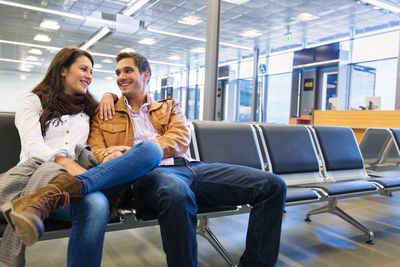 Young couple sitting at airport