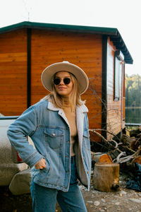 Young woman wearing sunglasses standing outdoors