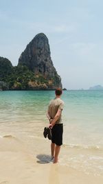 Rear view of woman standing on beach