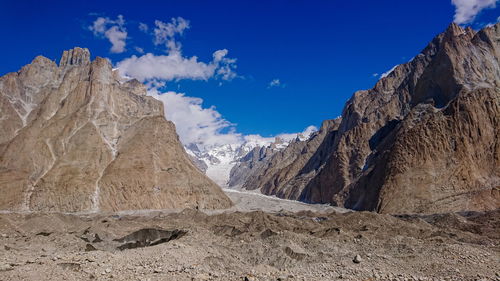 Scenic view of mountains against blue sky