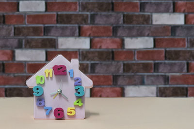 Close-up of toys on table against wall