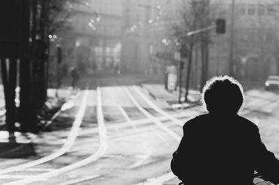 Rear view of man walking on street