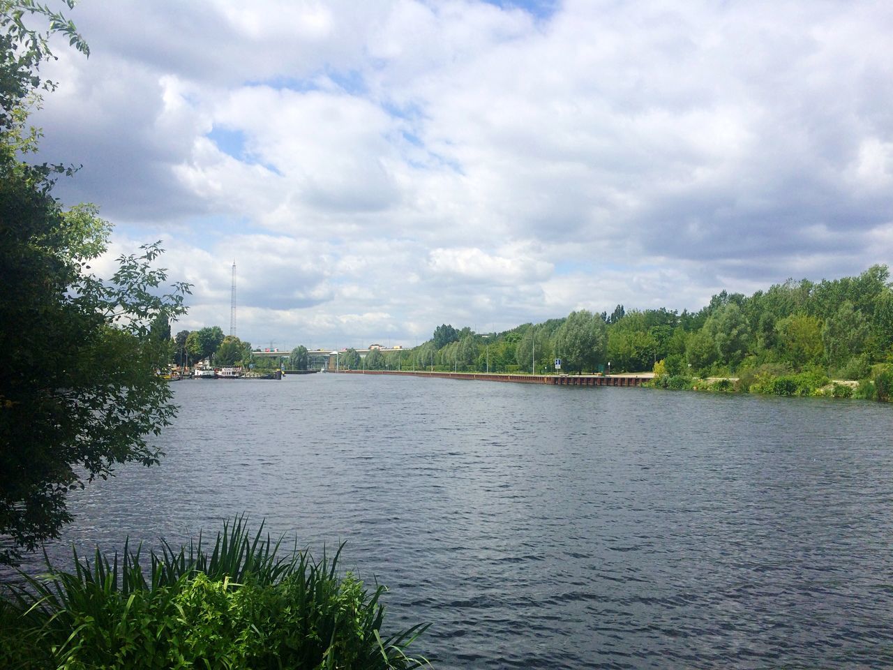 sky, water, tree, cloud - sky, tranquil scene, cloudy, tranquility, scenics, cloud, lake, beauty in nature, nature, river, rippled, growth, waterfront, idyllic, day, plant, non-urban scene