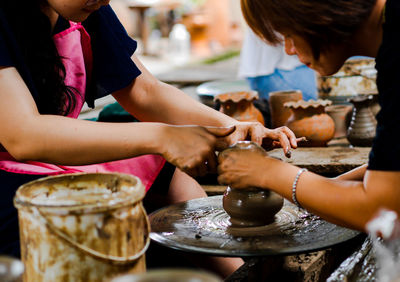 Women making pot in workshop