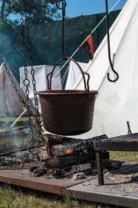 Rusty metal chain hanging on boat in water