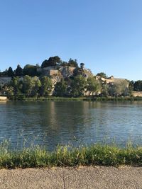 Scenic view of lake against clear blue sky