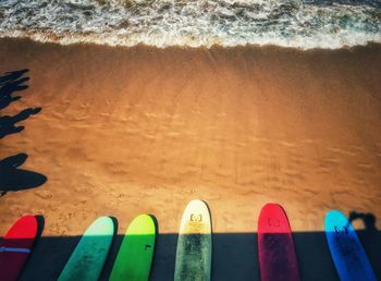 Close-up of shoes on beach