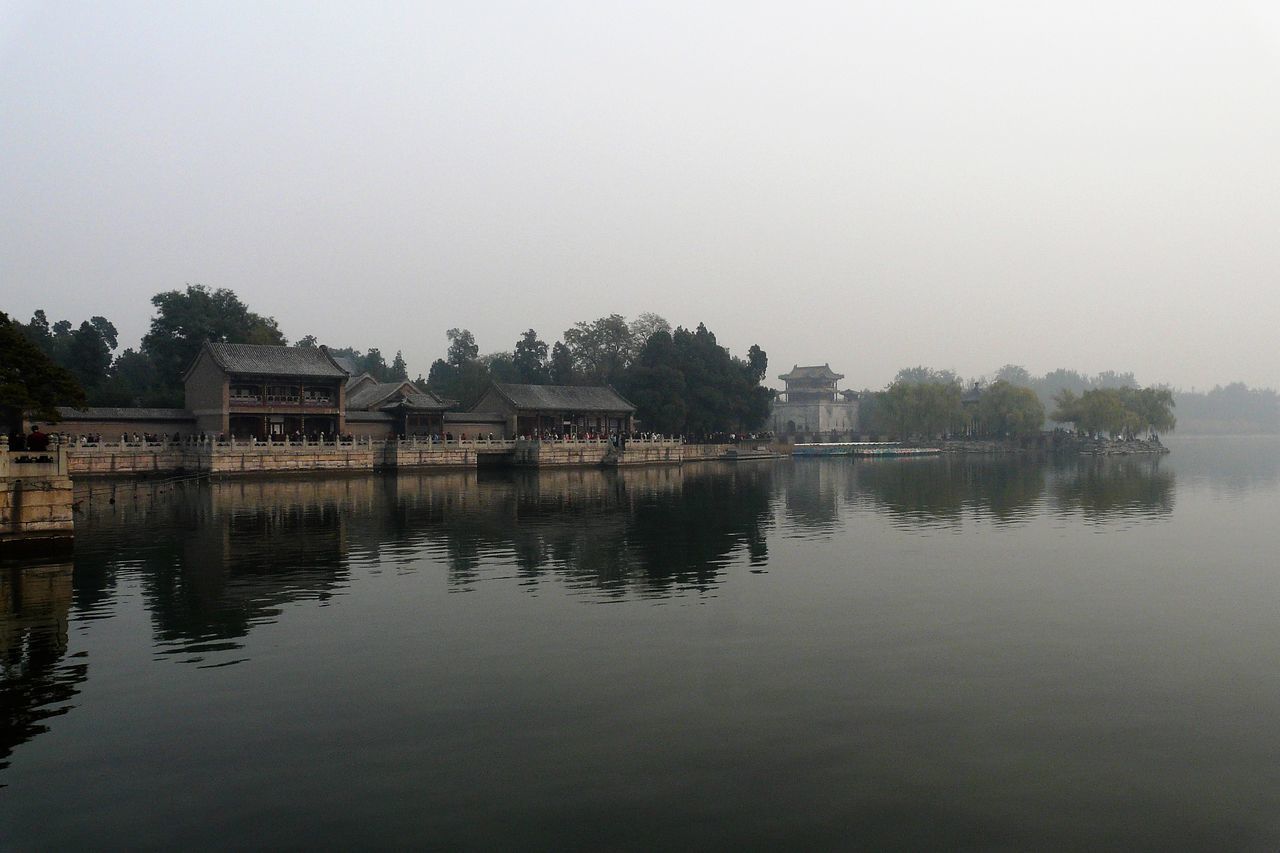 REFLECTION OF TREES AND BUILDINGS IN LAKE