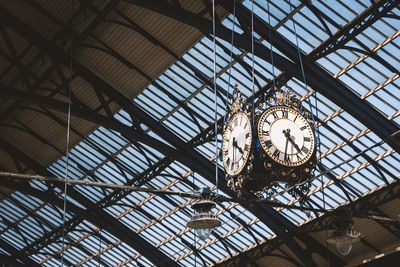 Low angle view of clock on ceiling at brighton station, uk.