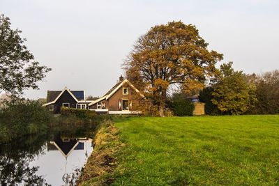 House by trees against clear sky