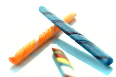 Close-up of multi colored pencils against white background