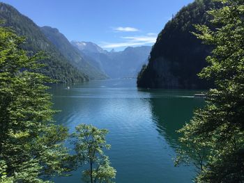 Calm lake against lush mountains