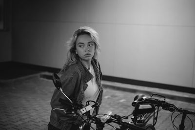 Woman standing by bicycle at basement