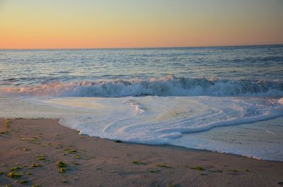 Scenic view of sea against clear sky during sunset