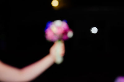 Close-up of hands against black background