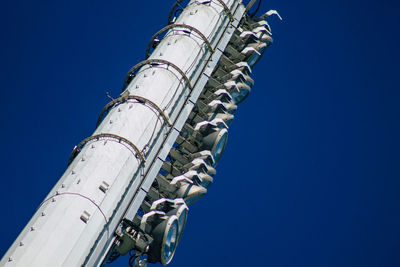 Low angle view of ferris wheel against blue sky